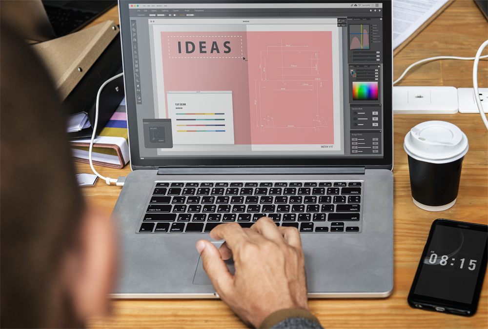 Designer working on a laptop at a desk