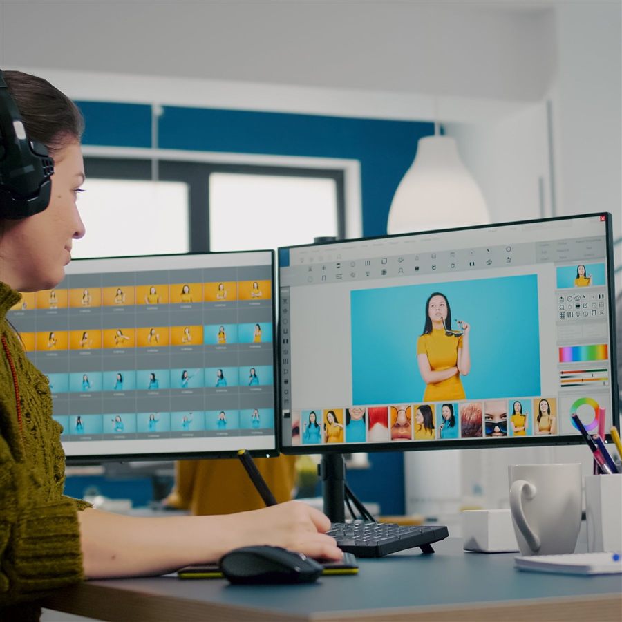Photo retoucher editing images with a stylus and multiple displays