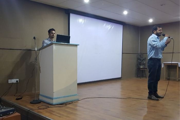 Speakers presenting on stage at an event