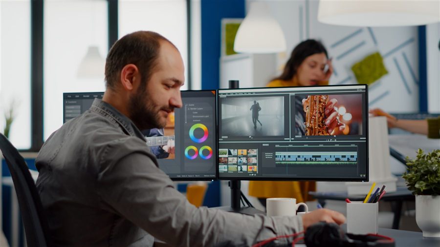 Video maker editing a movie in post-production software